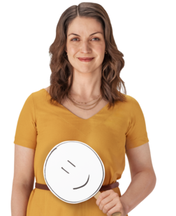 Female REXULTI user smiling while holding smiley face sign.